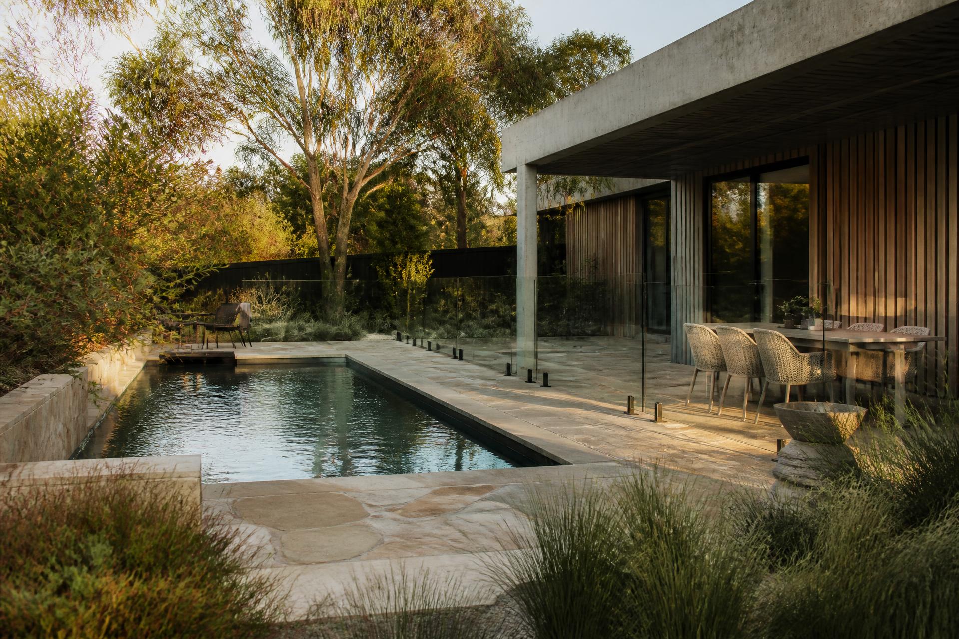 Contemporary Australian home with pool, natural stone paving and native garden